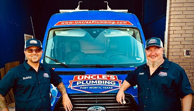 Bobby and Andy from Uncle's Plumbing team standing in front of their service van
